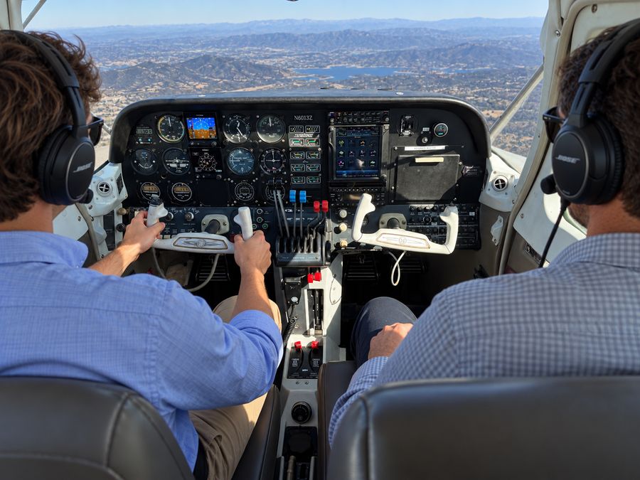 two pilots flying the twin-engine airplane over the mountains and lakes east of San Diego